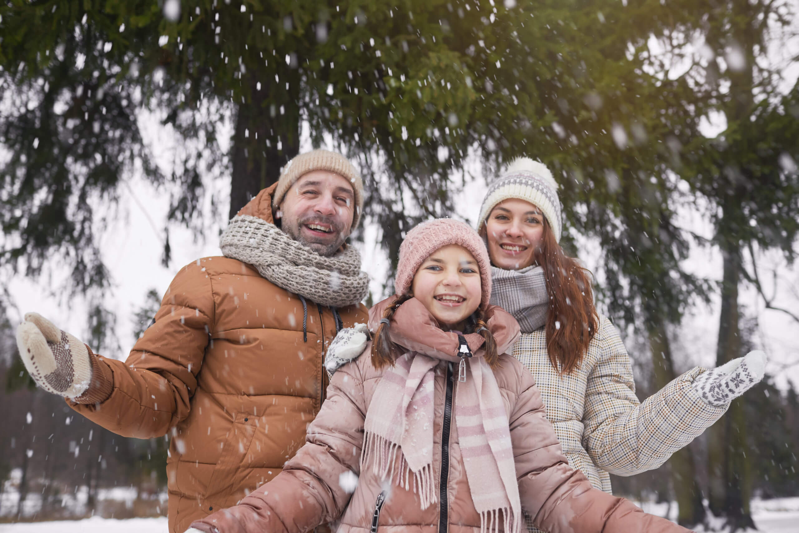 Family Playing with Snow in Winter